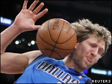 A basketball bouncing off a player's head