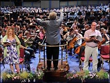 The conductor, singers and musicians performing
